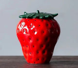 A ripe red strawberry on a table, perfect for Strawberry Tea and Coffee Pots